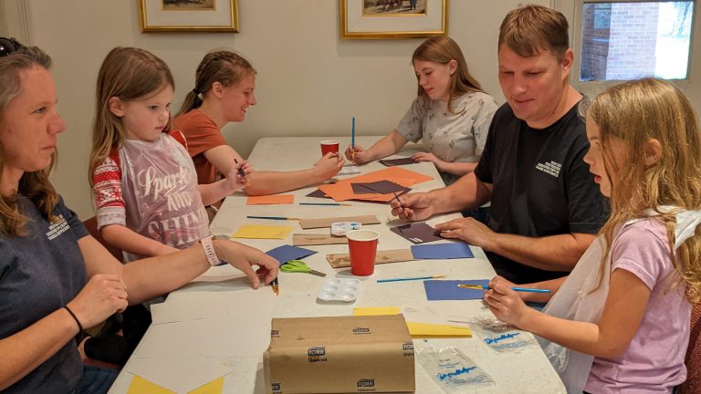 family of 6 doing crafts at steam sunday.