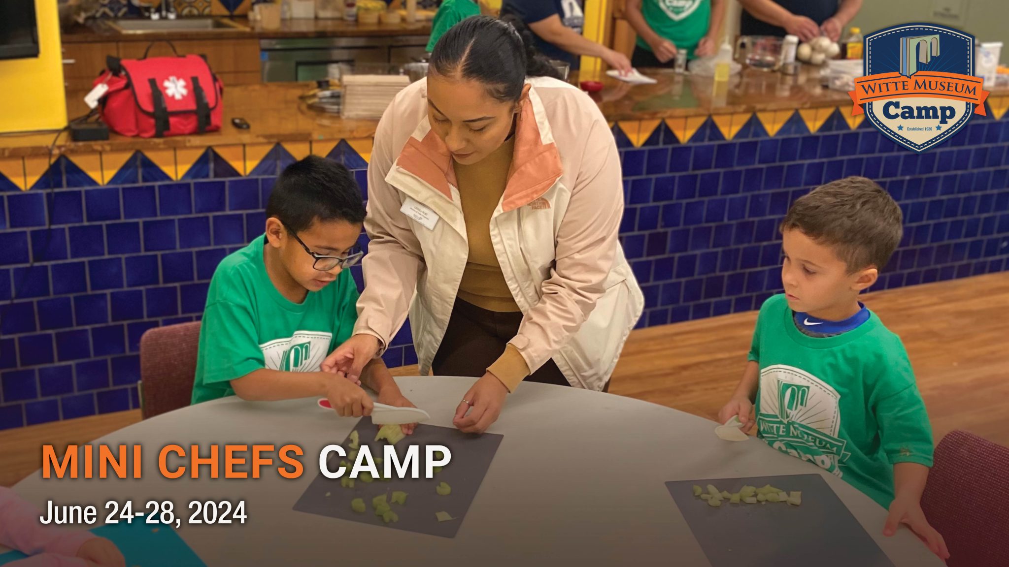 campers work with instructor to cut vegetables.