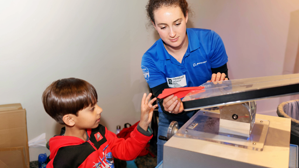 Boeing employee helps child with airplane