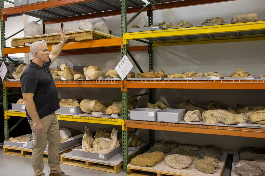 Dr. Adams showing fossil specimens