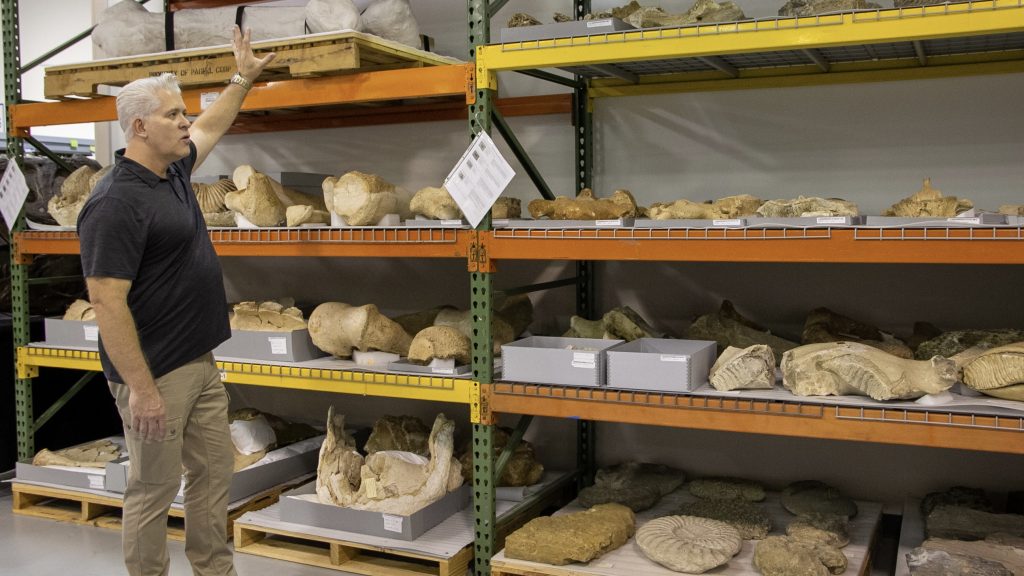 Dr. Adams showing fossil specimens