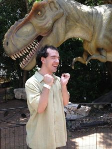 Ryan posing with a dinosaur